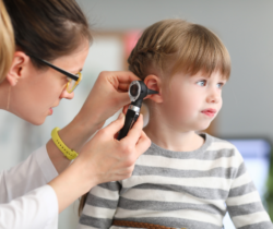 pediatrician looking in child's ear