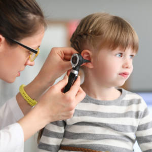 pediatrician looking in child's ear